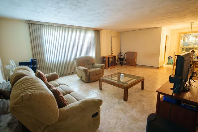 a living room with furniture rug and a window
