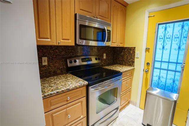 a kitchen with a stove and a microwave