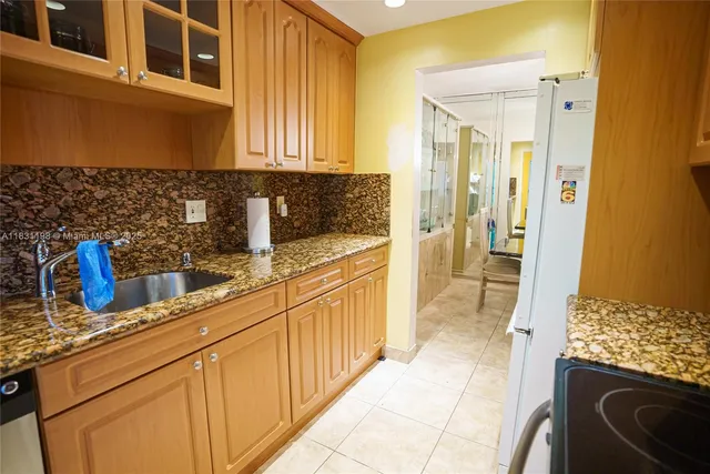 a kitchen with stainless steel appliances granite countertop a sink and cabinets