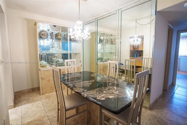 a dining room with furniture a chandelier and wooden floor
