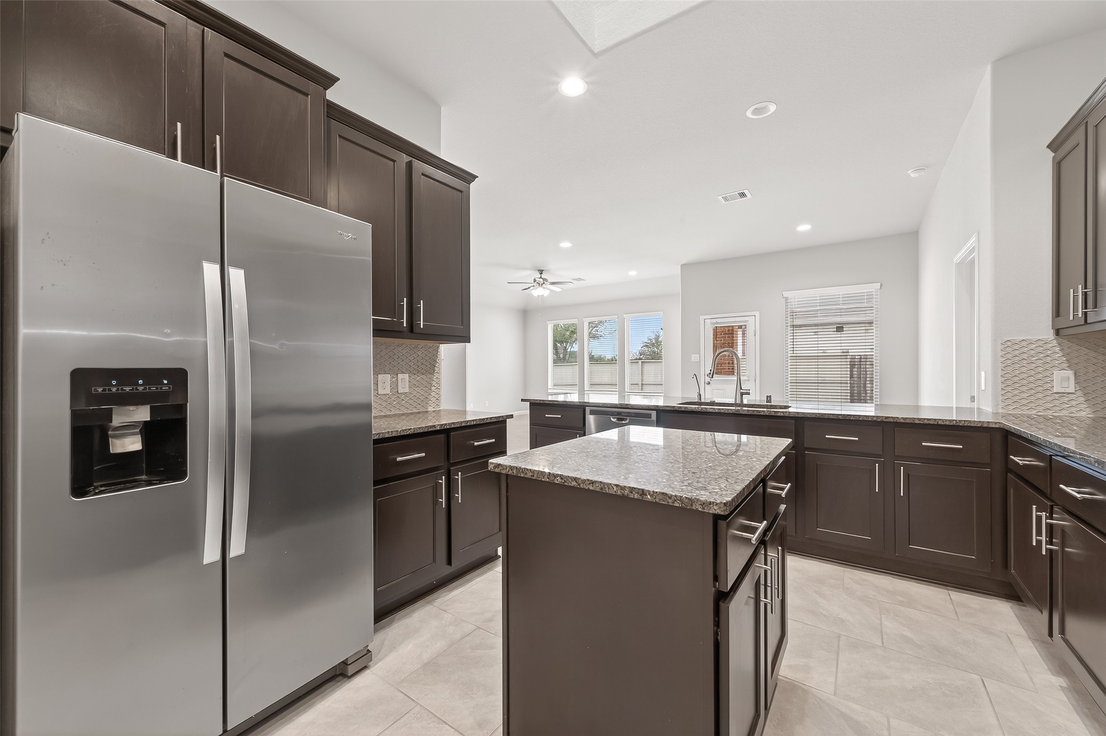 219 Verde Lake Way Rosenberg, TX 77469 - Photo 5 of 19 a kitchen with stainless steel appliances granite countertop refrigerator sink and stove