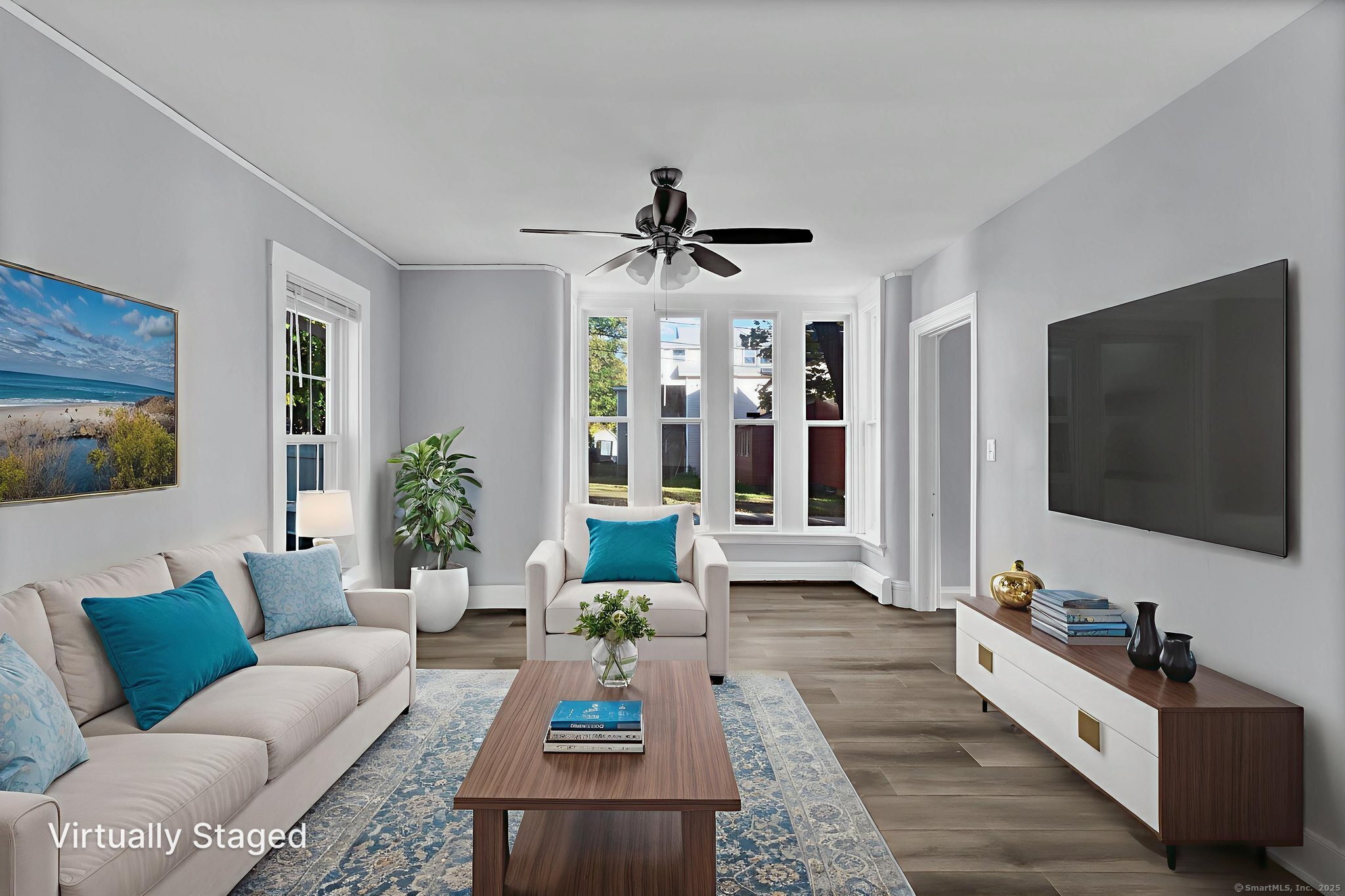 89 Spring Street Windham, CT 06226 - Photo 13 of 36 a living room with furniture and a flat screen tv