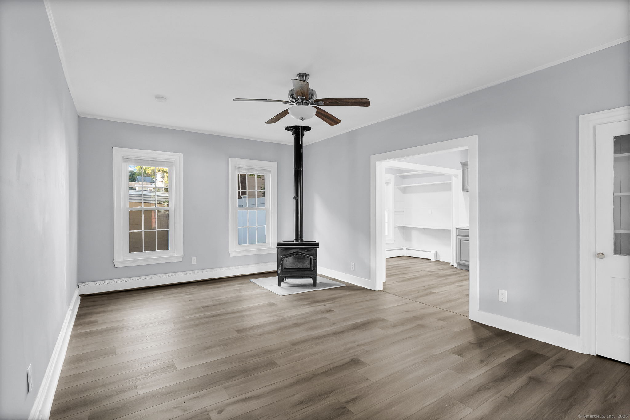 89 Spring Street Windham, CT 06226 - Photo 17 of 36 a view of an empty room with wooden floor and a window