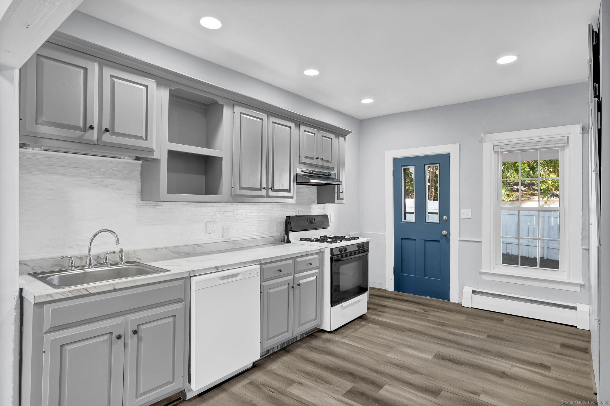 89 Spring Street Windham, CT 06226 - Photo 21 of 36 a kitchen with a sink cabinets stainless steel appliances and a window