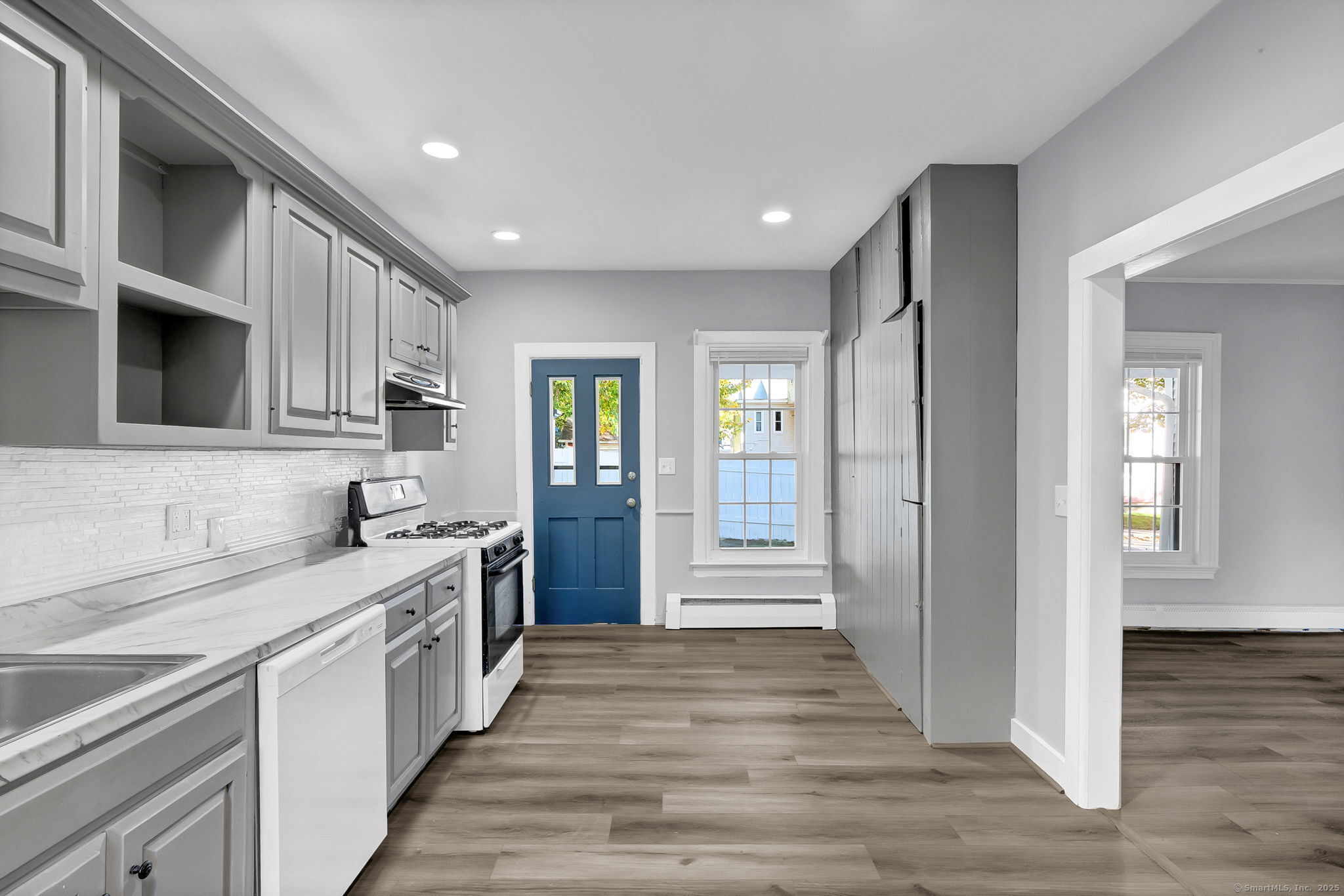 89 Spring Street Windham, CT 06226 - Photo 22 of 36 a large kitchen with stainless steel appliances granite countertop a sink and cabinets