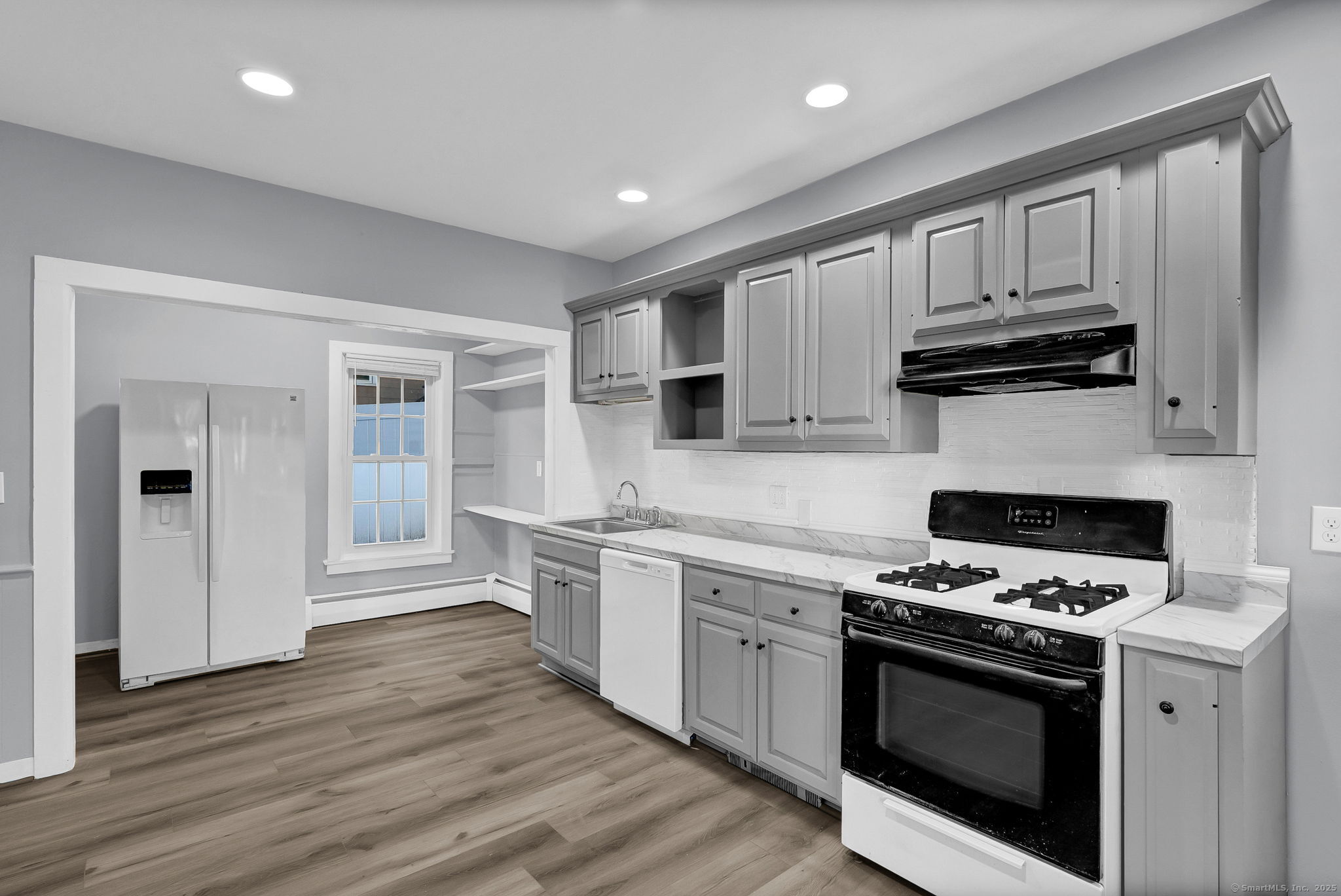 89 Spring Street Windham, CT 06226 - Photo 23 of 36 a kitchen with granite countertop wooden cabinets and stainless steel appliances