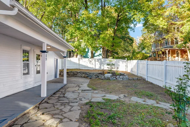 a view of a backyard with a tree