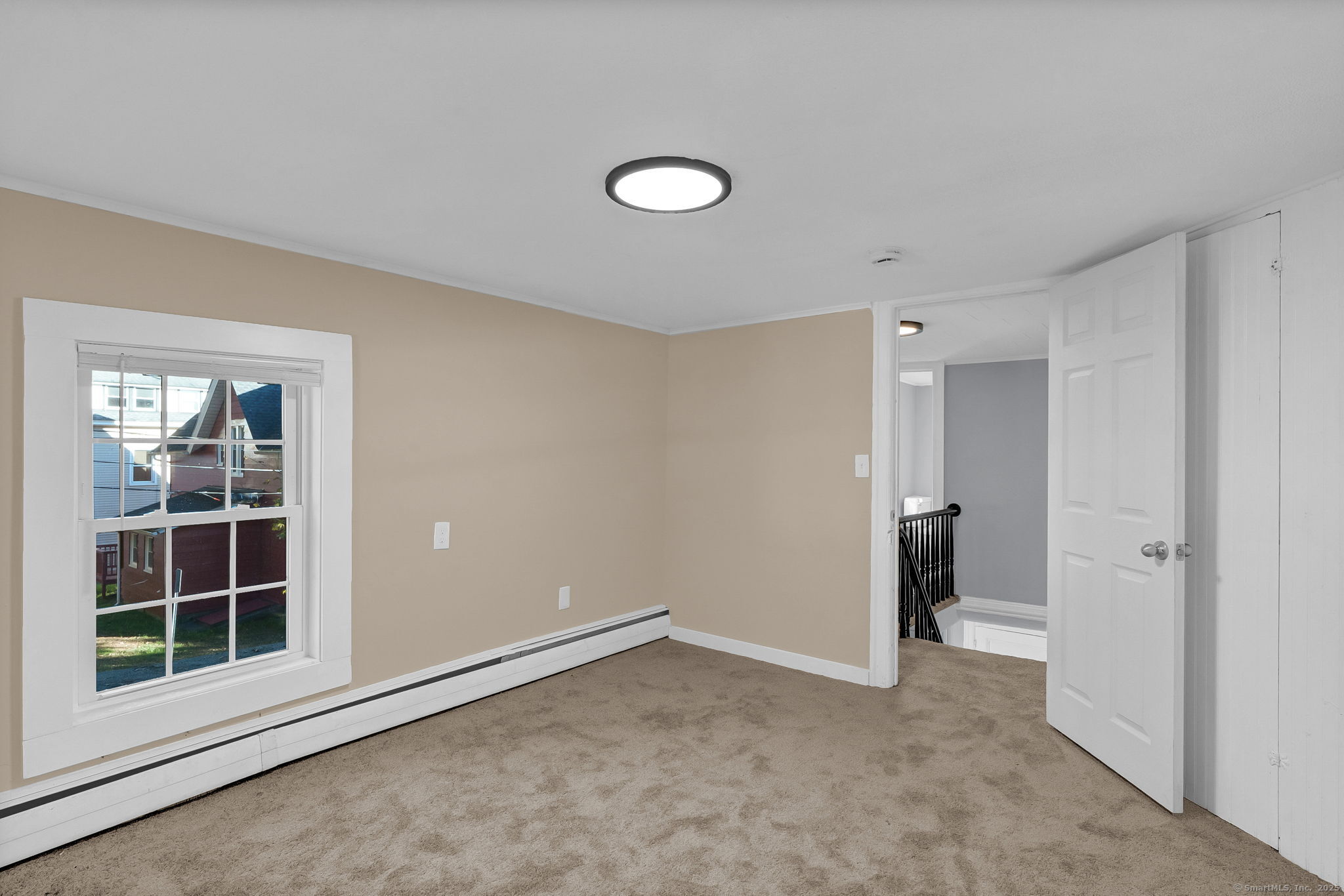 89 Spring Street Windham, CT 06226 - Photo 31 of 36 an empty room with windows and entrance