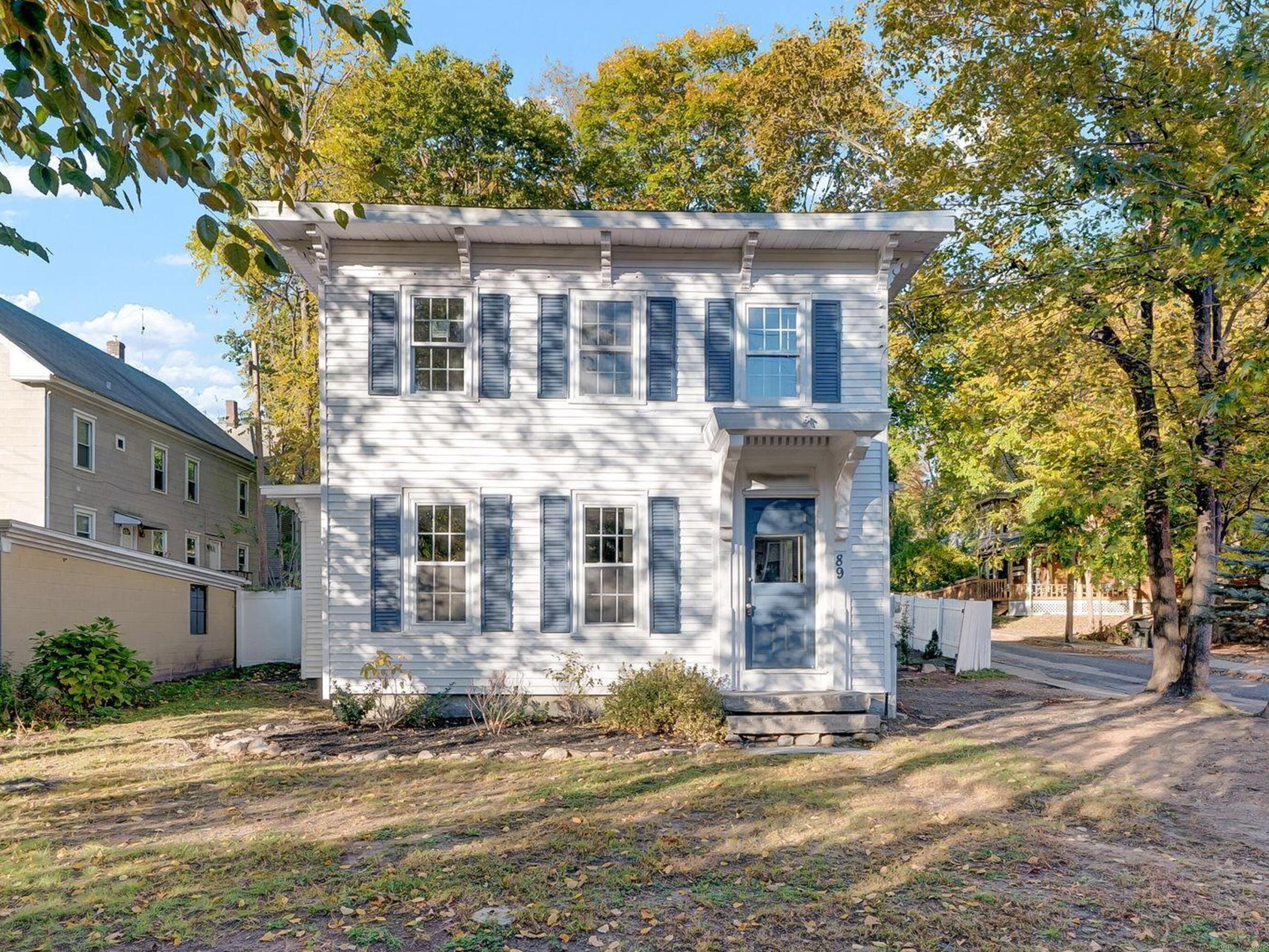 89 Spring Street Windham, CT 06226 - Photo 35 of 36 a front view of a house with a garden