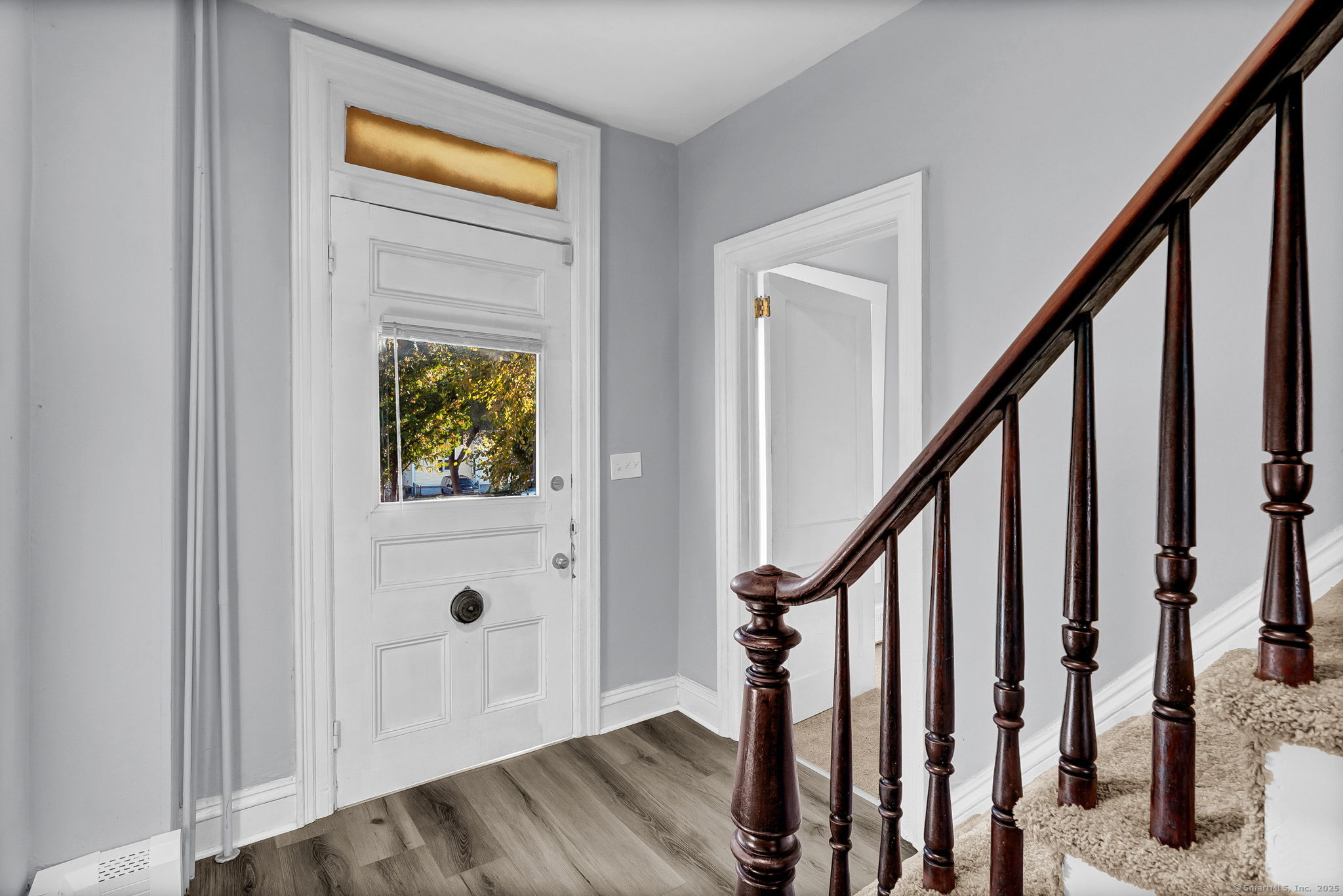 89 Spring Street Windham, CT 06226 - Photo 10 of 36 a view of front door with wooden floor and stairs