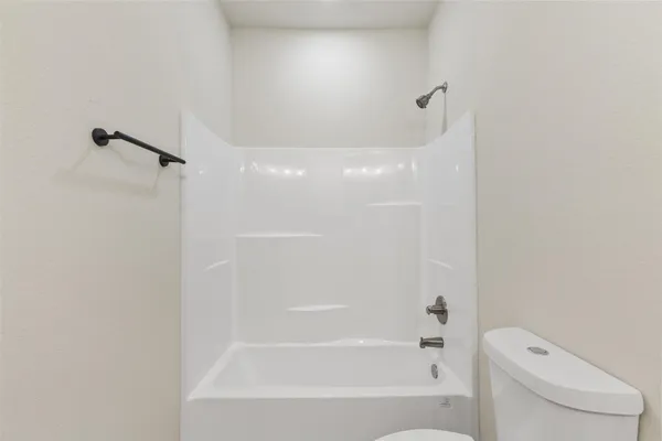 a bathroom with a bathtub and a toilet