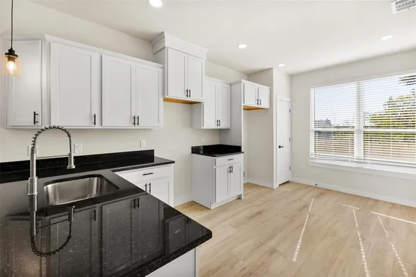 a close view of a sink and a vanity in the kitchen