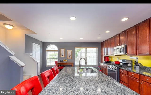 a large kitchen with granite countertop lots of counter top space