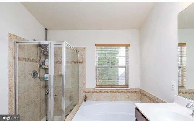 a bathroom with a bathtub and shower