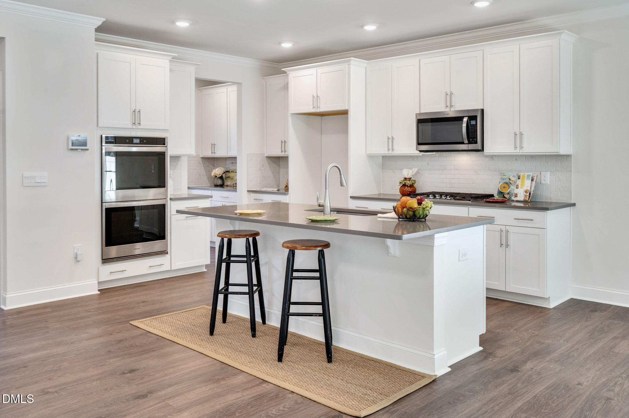 5112 Lizard Tail Lane Raleigh, NC 27603 - Photo 13 of 51 a kitchen with stainless steel appliances granite countertop a stove top oven a sink dishwasher and a refrigerator with wooden floor