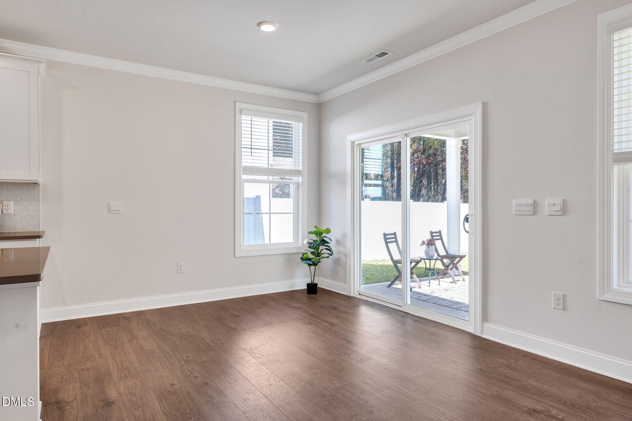 5112 Lizard Tail Lane Raleigh, NC 27603 - Photo 15 of 51 an empty room with wooden floor and windows