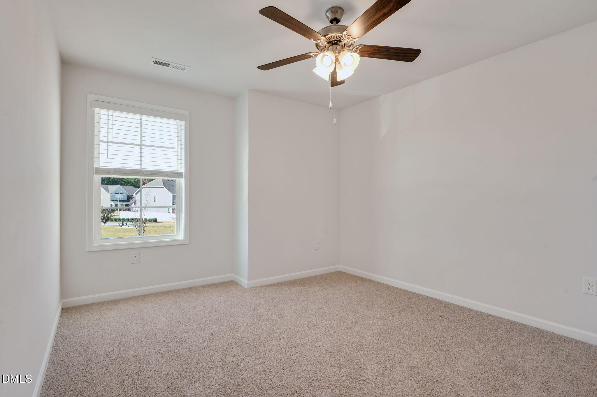 5112 Lizard Tail Lane Raleigh, NC 27603 - Photo 28 of 51 an empty room with windows and fan