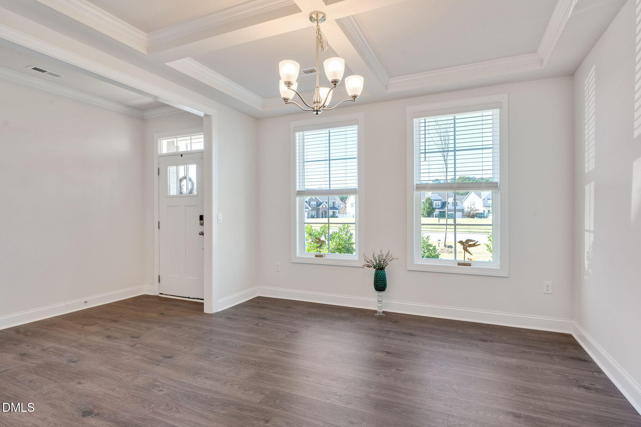 5112 Lizard Tail Lane Raleigh, NC 27603 - Photo 7 of 51 an empty room with wooden floor and windows