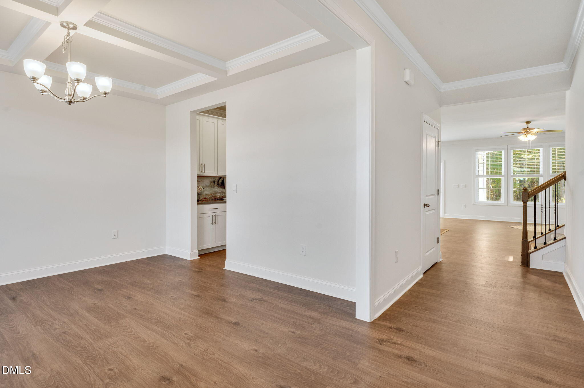 5112 Lizard Tail Lane Raleigh, NC 27603 - Photo 9 of 51 a view of a hallway with wooden floor and a chandelier