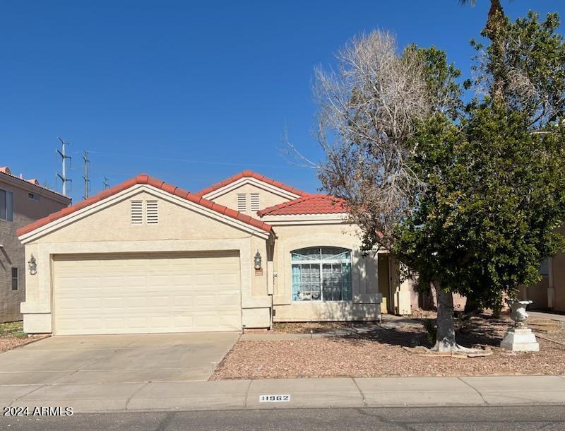 11962 West Coronado Road Avondale, AZ 85392 - Photo 1 of 23 a front view of a house with a garage