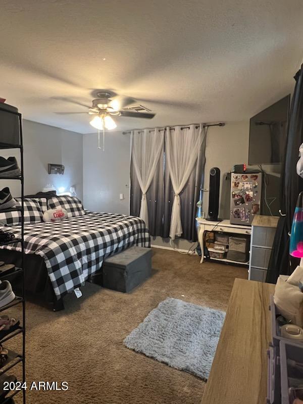 11962 West Coronado Road Avondale, AZ 85392 - Photo 12 of 23 a bedroom with furniture and a flat screen tv