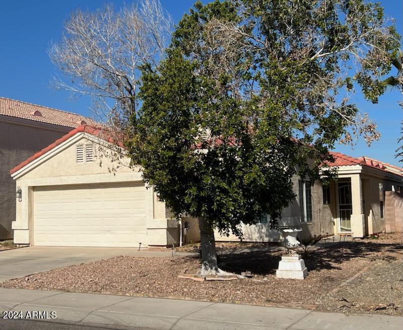 11962 West Coronado Road Avondale, AZ 85392 - Photo 2 of 23 a front view of a house with fountain