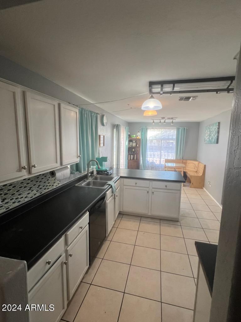 11962 West Coronado Road Avondale, AZ 85392 - Photo 4 of 23 a large white kitchen with a stove a sink and a refrigerator