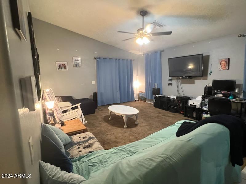 11962 West Coronado Road Avondale, AZ 85392 - Photo 8 of 23 a bedroom with furniture and a flat screen tv