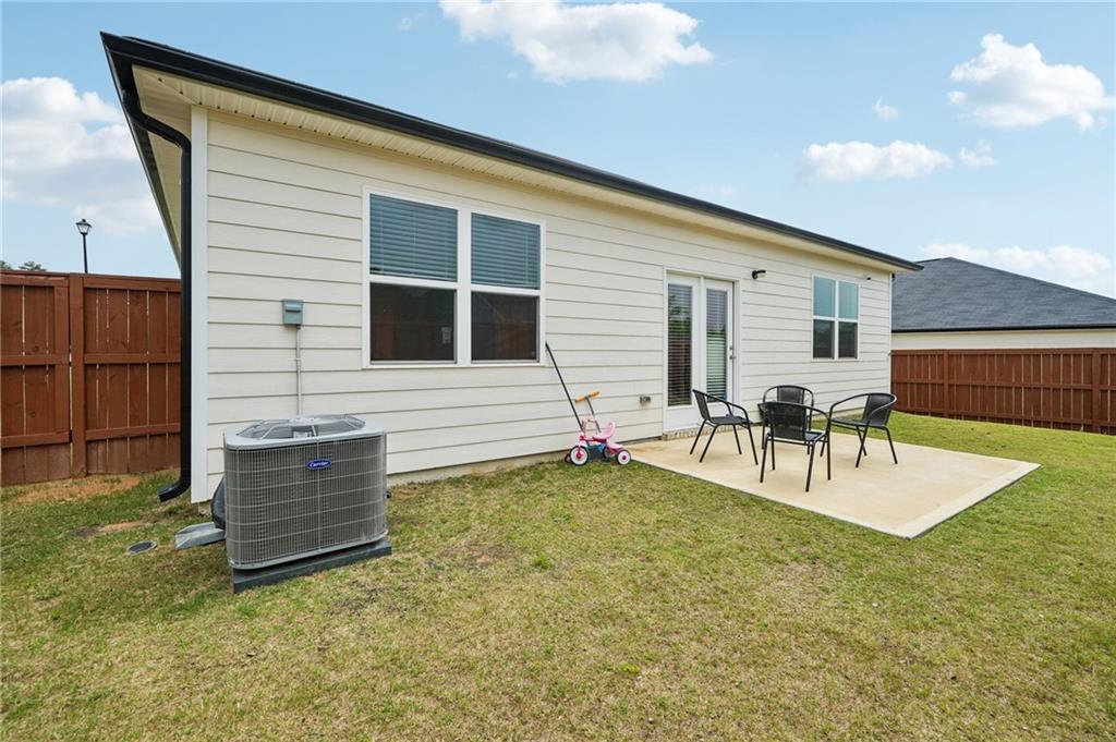 8592 Seabiscuit Road Lithonia, GA 30058 - Photo 21 of 25 a backyard of a house with table and chairs
