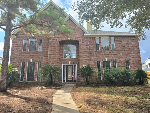 a view of a brick house with a large windows