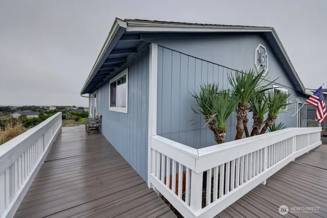 a view of a house with wooden deck