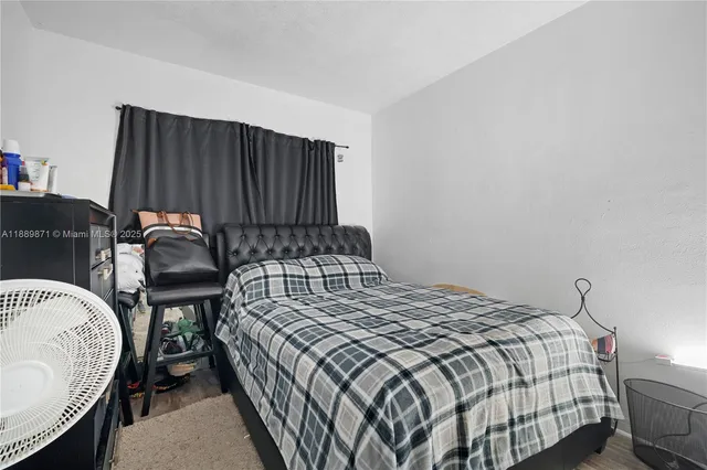 a bedroom with a bed and a shower