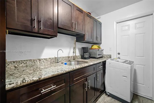 a kitchen with stainless steel appliances granite countertop a sink stove and cabinets