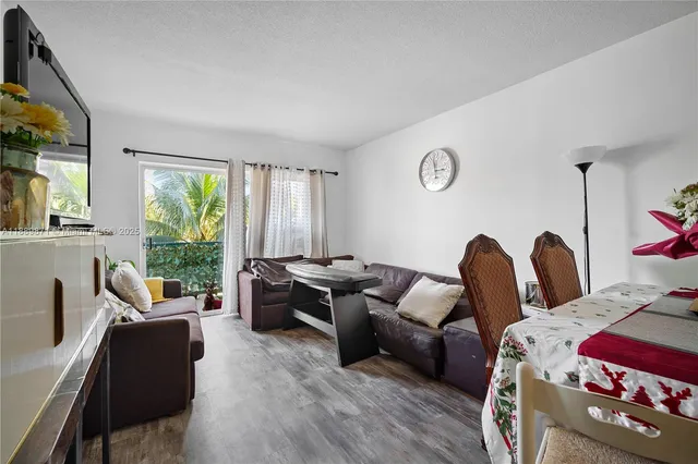 a living room with furniture a rug and a table