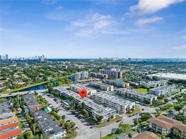 a view of a swimming pool with lawn chairs and a yard