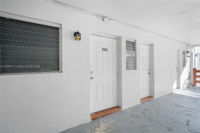 a view of a hallway with wooden floor and closet