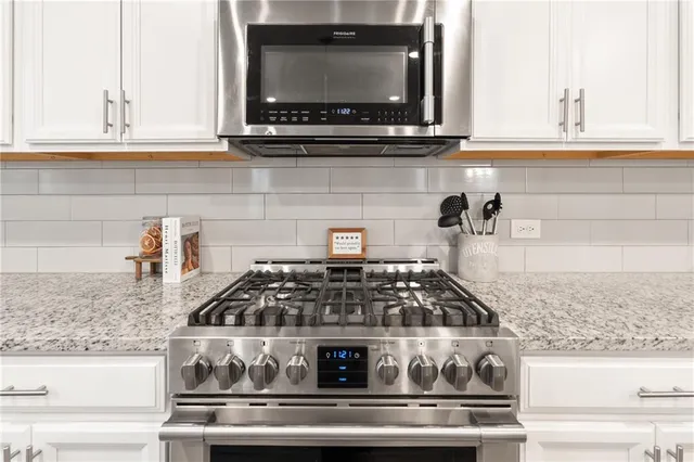 a kitchen with a stove and a microwave