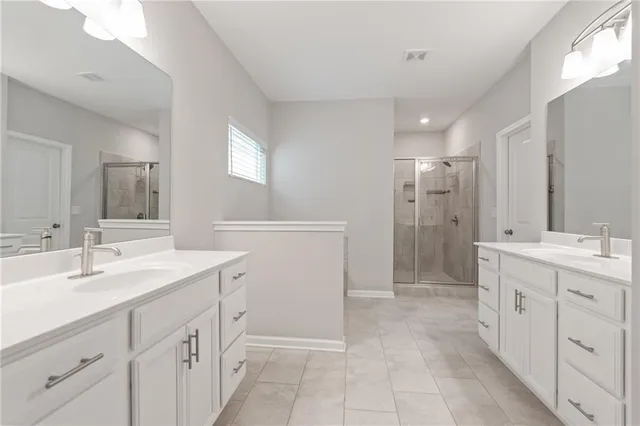 a spacious bathroom with a shower sink and mirror