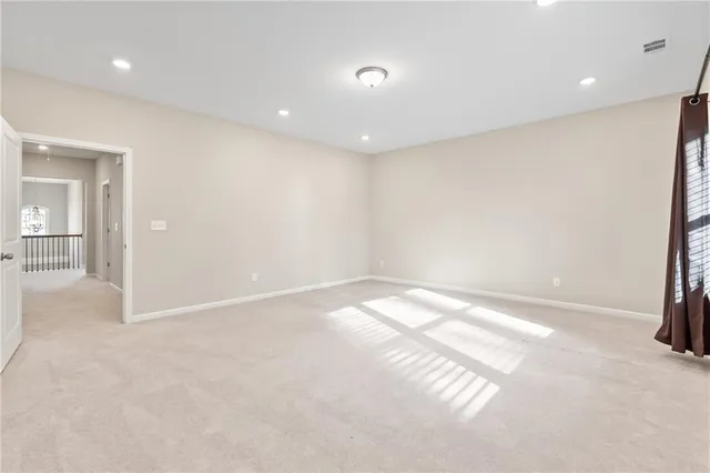 a white toilet sitting next to a white wall