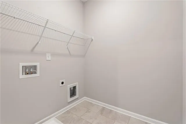 a bed sitting in a spacious bedroom next to a window