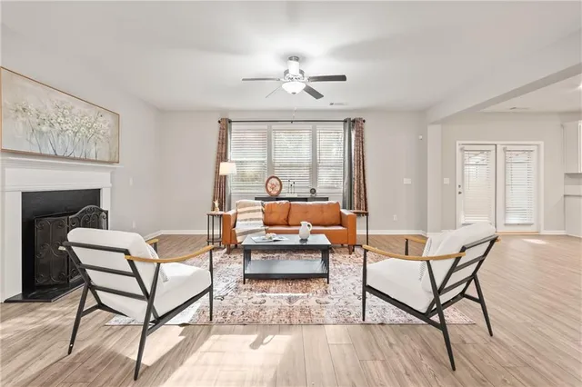 a living room with furniture a fireplace and wooden floor