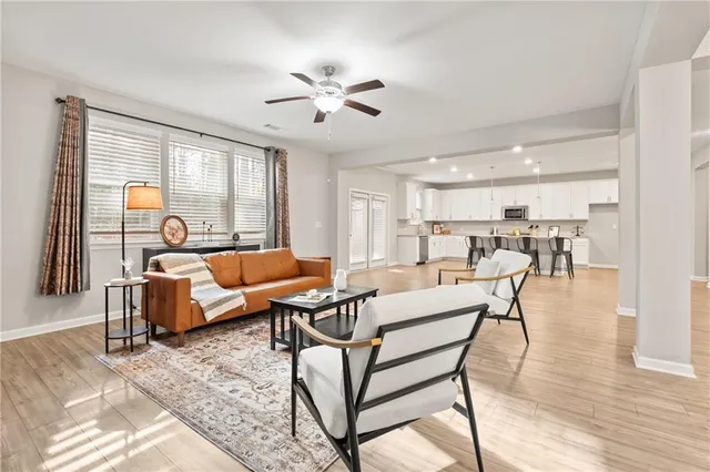 a living room with furniture and wooden floor