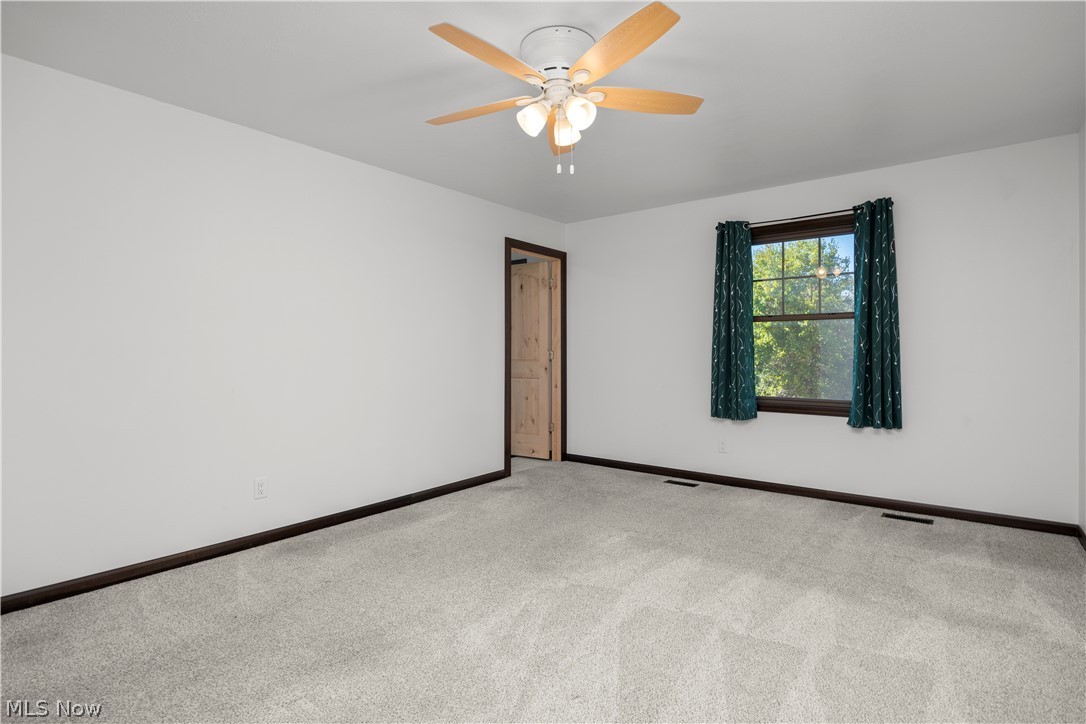 6760 Mason Road Berlin Heights, OH 44814 - Photo 16 of 49 Empty room with carpet and ceiling fan