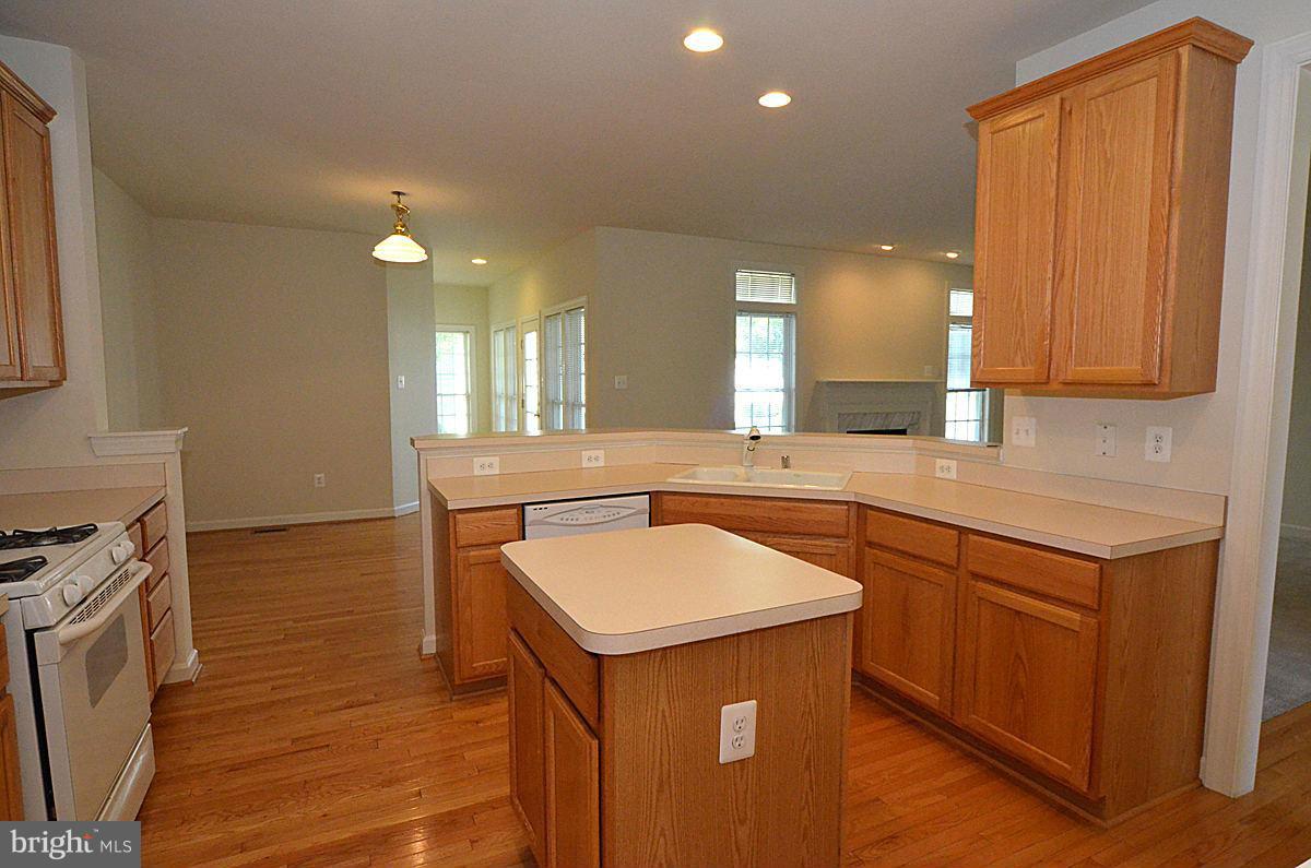 23506 Clarksburg Road Clarksburg, MD 20871 - Photo 3 of 29 a kitchen with a sink cabinets and wooden floor