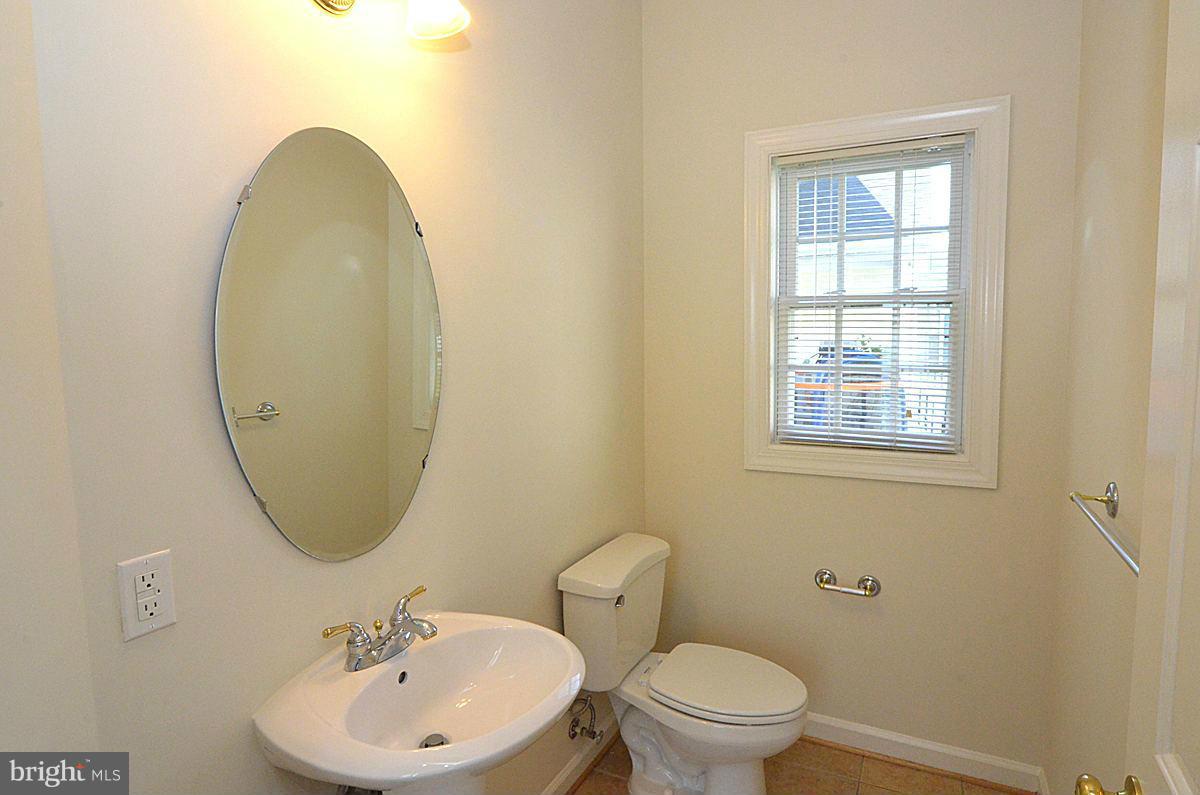 23506 Clarksburg Road Clarksburg, MD 20871 - Photo 24 of 29 a bathroom with a toilet sink and mirror