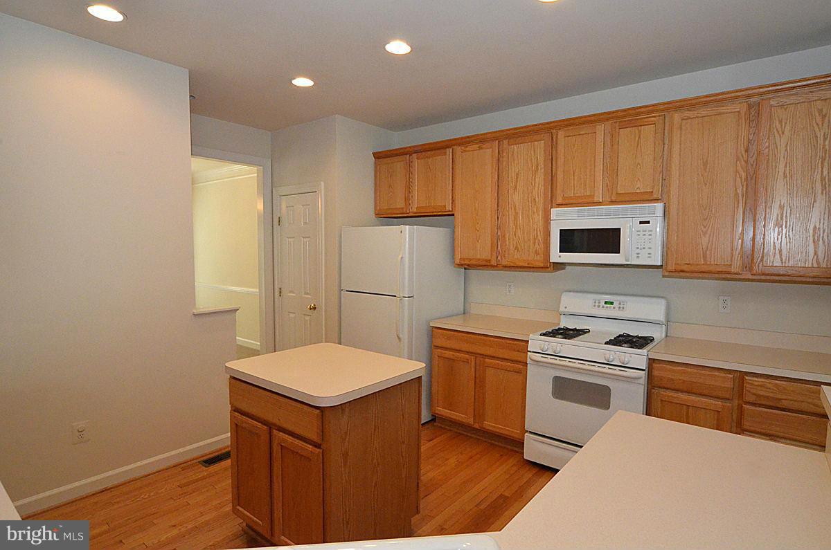23506 Clarksburg Road Clarksburg, MD 20871 - Photo 4 of 29 a kitchen with a refrigerator sink and cabinets