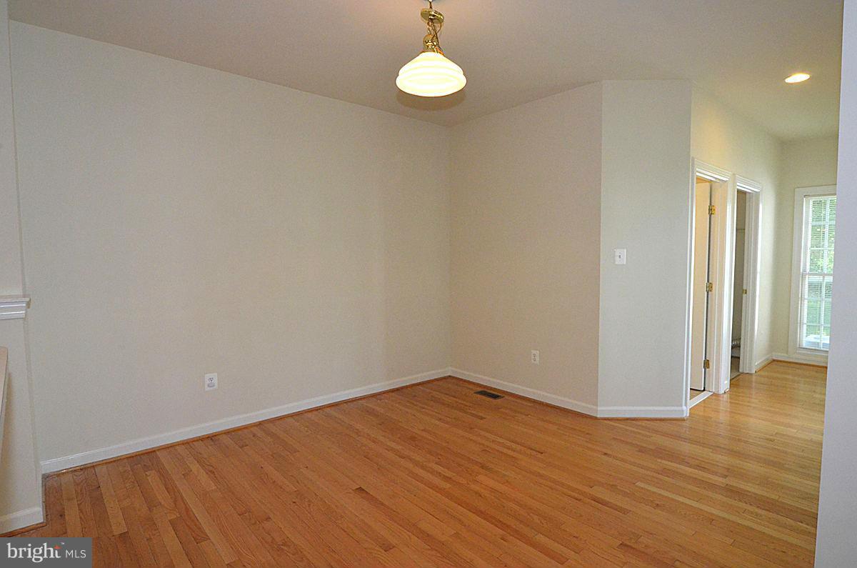 23506 Clarksburg Road Clarksburg, MD 20871 - Photo 6 of 29 a view of a room with wooden floor and glass doors