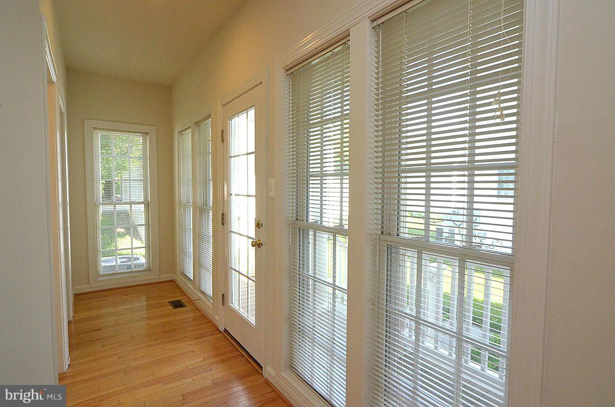 23506 Clarksburg Road Clarksburg, MD 20871 - Photo 8 of 29 a view of an empty room with wooden floor and a window