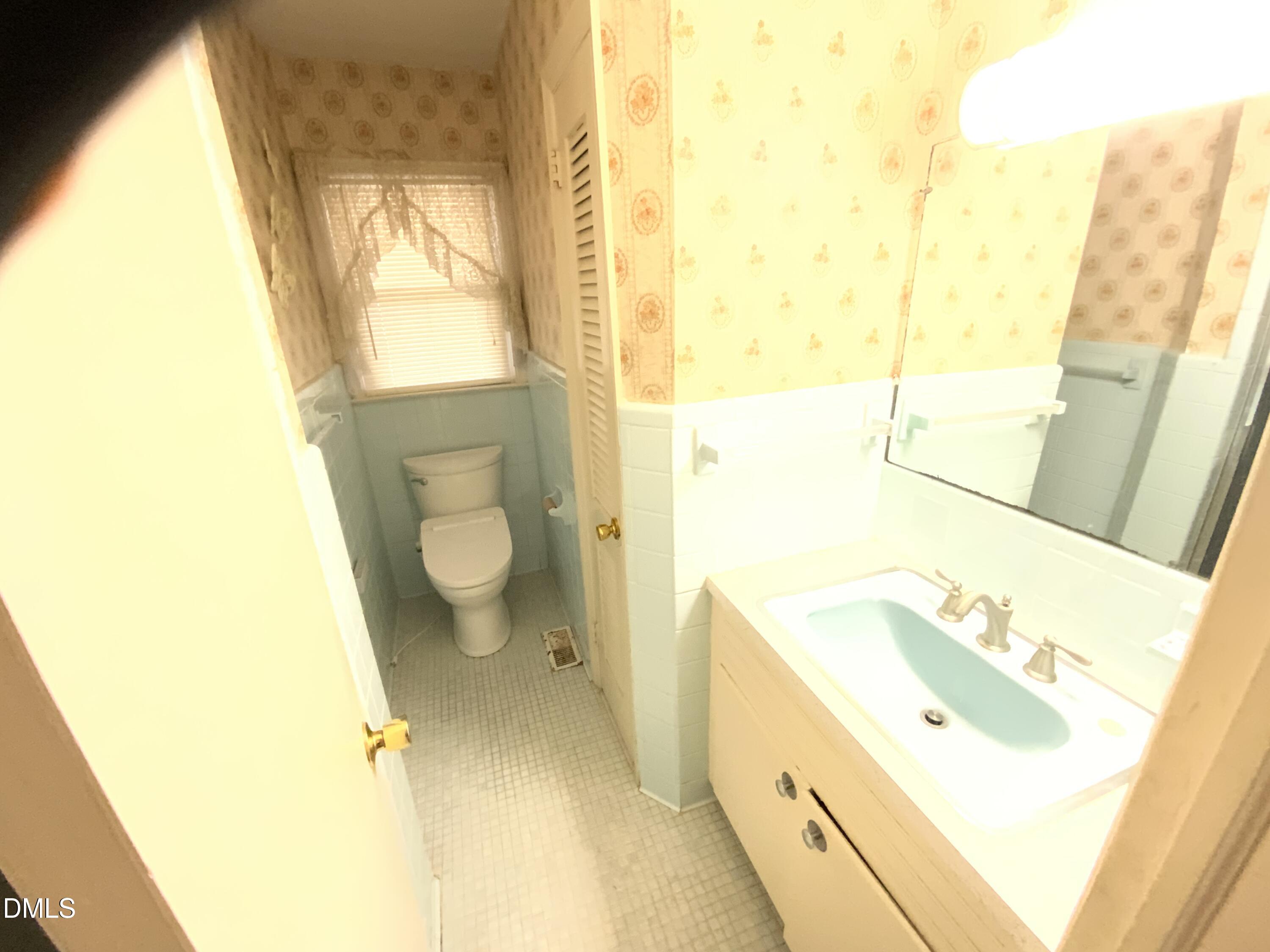 100 East C Street Erwin, NC 28339 - Photo 15 of 21 a bathroom with a sink a toilet and a bathtub
