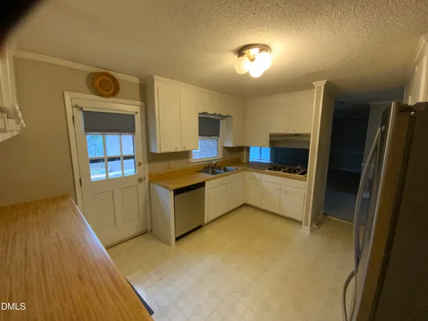 a kitchen with stainless steel appliances a refrigerator and a stove